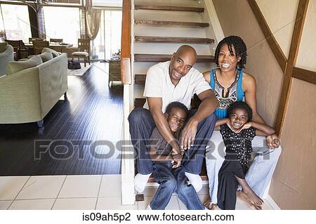 Portrait of mature couple with son and daughter on stairs View Large Photo Image Stock Image - Portrait of mature couple with son and daughter on stairs. Fotosearch