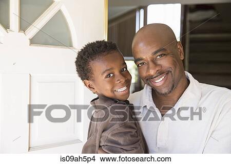 Portrait of mature man and son at front door View Large Photo Image Picture - Portrait of mature man and son at front door. Fotosearch