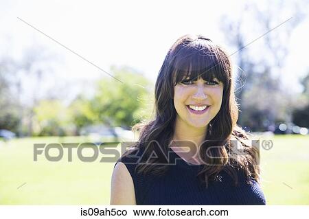 Portrait of mid adult woman in park View Large Photo Image Picture - Portrait of mid adult woman in park. Fotosearch