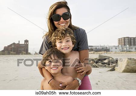 Stock Image - Portrait of mother and two boys, Long Beach, New York State, USA. Fotosearch