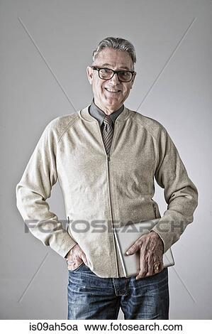 Portrait of senior man, hand in pocket, holding bag View Large Photo Image Stock Image - Portrait of senior man, hand in pocket, holding bag. Fotosearch