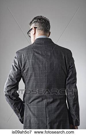 Stock Photo - Portrait of senior man, wearing suit, rear view. Fotosearch