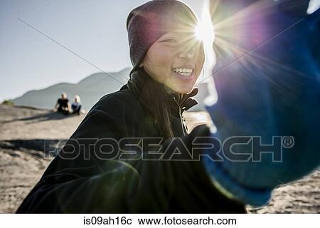 Stock Image - Portrait of shy young female hiker, Squamish, British Columbia, Canada. Fotosearch
