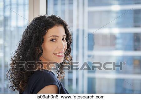 Portrait of young businesswoman in front of window View Large Photo Image Stock Photograph - Portrait of young businesswoman in front of window. Fotosearch