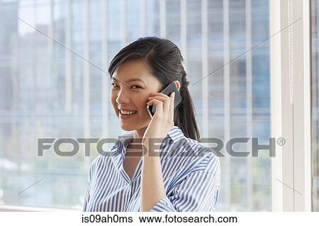 Portrait of young businesswoman using cellphone View Large Photo Image Stock Photograph - Portrait of young businesswoman using cellphone. Fotosearch