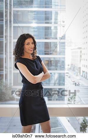 Portrait of young businesswoman with arms folded View Large Photo Image Stock Photo - Portrait of young businesswoman with arms folded. Fotosearch