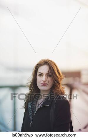 Stock Photography - Portrait of young woman outdoors. Fotosearch