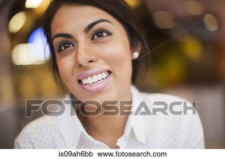Stock Image - Portrait of young woman, smiling. Fotosearch