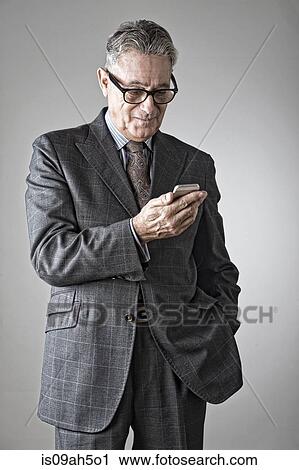 Stock Image - Senior man using mobile phone. Fotosearch
