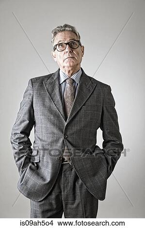 Senior man with hands in pockets, looking up View Large Photo Image Picture - Senior man with hands in pockets, looking up. Fotosearch