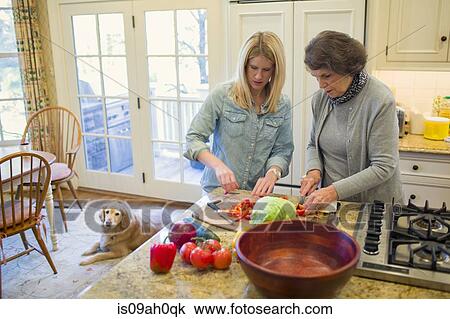 Senior woman and granddaughter chopping vegetables for salad bowl View Large Photo Image Stock Image - Senior woman and granddaughter chopping vegetables for salad bowl. Fotosearch