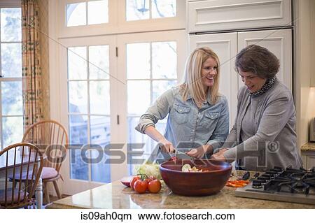 Senior woman and granddaughter preparing salad View Large Photo Image Picture - Senior woman and granddaughter preparing salad. Fotosearch