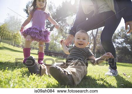 Siblings playing in park View Large Photo Image Picture - Siblings playing in park. Fotosearch