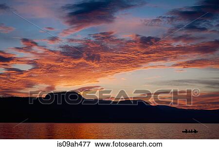 Silhouetted family paddling a canoe over Okanagan Lake, Naramata, British Columbia, Canada View Large Photo Image Stock Photo - Silhouetted family paddling a canoe over Okanagan Lake, Naramata, British Columbia, Canada. Fotosearch