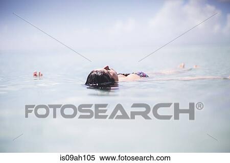 Woman floating in the sea View Large Photo Image Stock Photography - Woman floating in the sea. Fotosearch