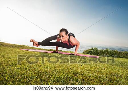 Women on cliff, in yoga position View Large Photo Image Picture - Women on cliff, in yoga position. Fotosearch