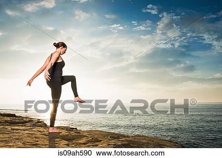 Women on cliff, in yoga position View Large Photo Image Stock Image - Women on cliff, in yoga position. Fotosearch