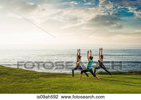 Women on cliff, in yoga position View Large Photo Image Stock Image - Women on cliff, in yoga position. Fotosearch