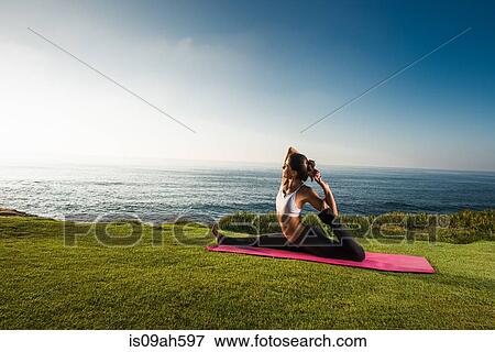 Women on cliff, in yoga position View Large Photo Image Stock Photo - Women on cliff, in yoga position. Fotosearch