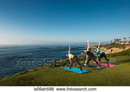 Women on cliff, in yoga position View Large Photo Image Stock Photo - Women on cliff, in yoga position. Fotosearch