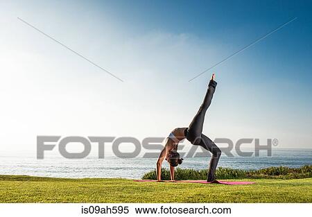 Women on cliff, in yoga position View Large Photo Image Stock Photography - Women on cliff, in yoga position. Fotosearch