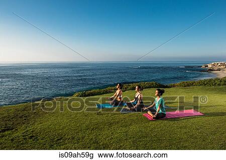 Women on cliff, meditating View Large Photo Image Stock Image - Women on cliff, meditating. Fotosearch