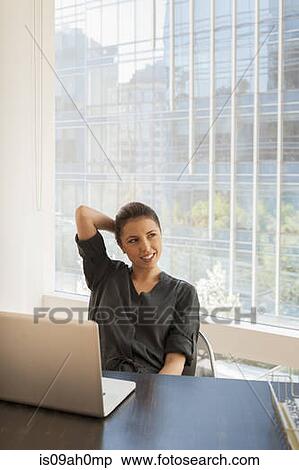 Young businesswoman daydreaming in office View Large Photo Image Stock Photography - Young businesswoman daydreaming in office. Fotosearch