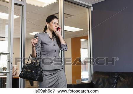 Young businesswoman leaving office, on phonecall View Large Photo Image Stock Photo - Young businesswoman leaving office, on phonecall. Fotosearch