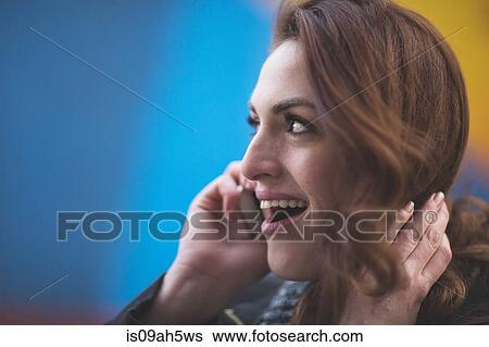 Young businesswoman talking on cellphone on city street View Large Photo Image Stock Photograph - Young businesswoman talking on cellphone on city street. Fotosearch