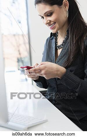 Young businesswoman using smartphone View Large Photo Image Stock Image - Young businesswoman using smartphone. Fotosearch