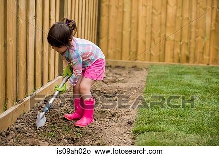 Young girl digging in the garden View Large Photo Image Picture - Young girl digging in the garden. Fotosearch