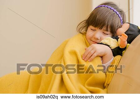 Young girl lying on sofa pretending to sleep View Large Photo Image Stock Photography - Young girl lying on sofa pretending to sleep. Fotosearch