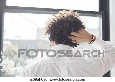 Young man scratching head, rear view View Large Photo Image Stock Photograph - Young man scratching head, rear view. Fotosearch
