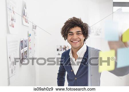 Young man with adhesive notes, smiling View Large Photo Image Stock Photo - Young man with adhesive notes, smiling. Fotosearch