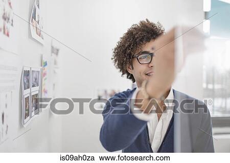 Stock Image - Young man with adhesive notes. Fotosearch