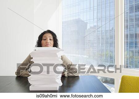 Young office worker with stack of paperwork View Large Photo Image Stock Image - Young office worker with stack of paperwork. Fotosearch