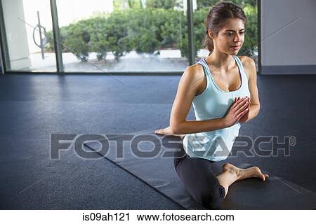 Young woman in meditating pose View Large Photo Image Stock Image - Young woman in meditating pose. Fotosearch