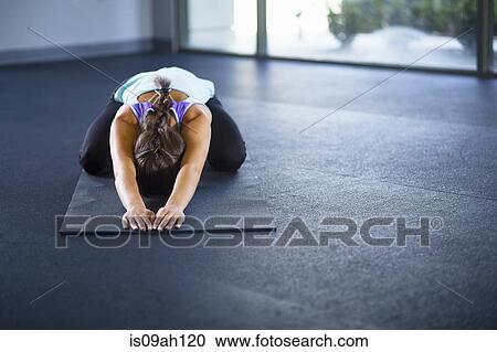 Stock Image - Young woman in tortoise pose. Fotosearch
