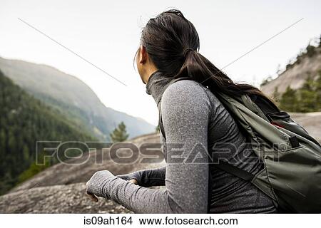 Young woman looking at view, Squamish, British Columbia, Canada View Large Photo Image Picture - Young woman looking at view, Squamish, British Columbia, Canada. Fotosearch