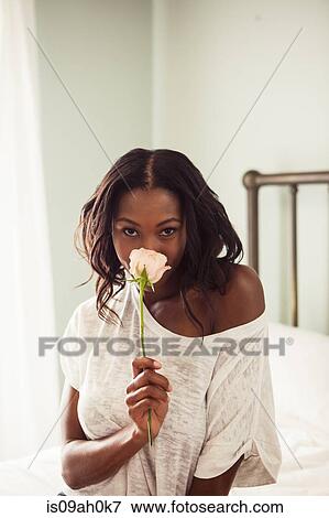 Young woman smelling rose View Large Photo Image Stock Photo - Young woman smelling rose. Fotosearch