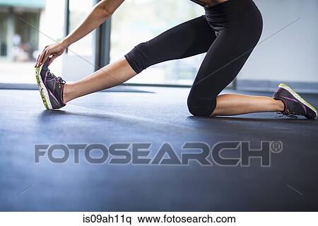 Stock Photography - Young woman stretching. Fotosearch