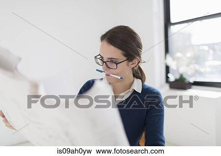 Young woman studying blueprint View Large Photo Image Stock Photo - Young woman studying blueprint. Fotosearch