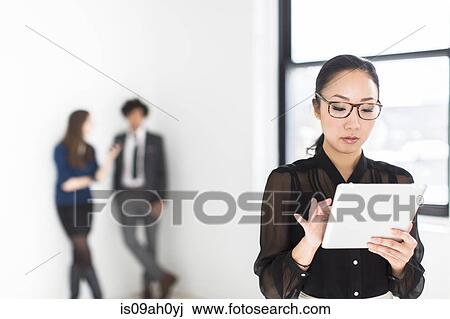 Young woman using digital tablet View Large Photo Image Stock Image - Young woman using digital tablet. Fotosearch