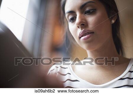 Stock Image - Young woman using laptop computer. Fotosearch