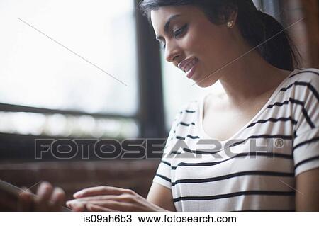 Stock Image - Young woman using laptop computer. Fotosearch