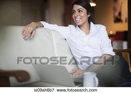 Stock Photo - Young woman using laptop computer. Fotosearch
