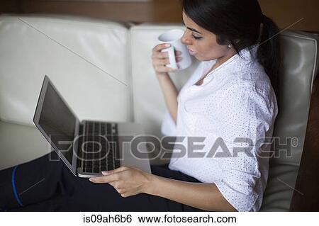 Young woman using laptop computer View Large Photo Image Stock Photograph - Young woman using laptop computer. Fotosearch