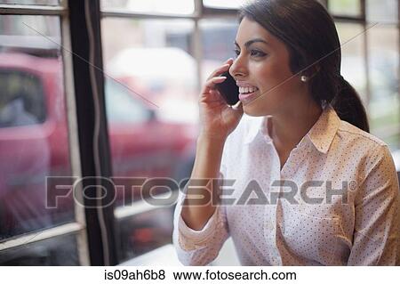 Young woman using smartphone View Large Photo Image Stock Photo - Young woman using smartphone. Fotosearch