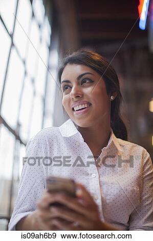 Stock Photo - Young woman using smartphone. Fotosearch