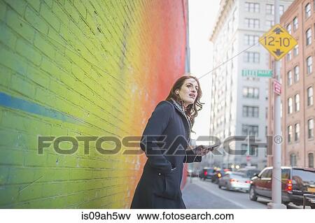 Young woman waiting on city street View Large Photo Image Stock Photo - Young woman waiting on city street. Fotosearch
